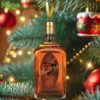 E H Taylor bourbon bottle ornament hanging on a Christmas tree.