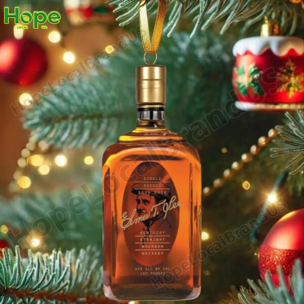 E H Taylor bourbon bottle ornament hanging on a Christmas tree.