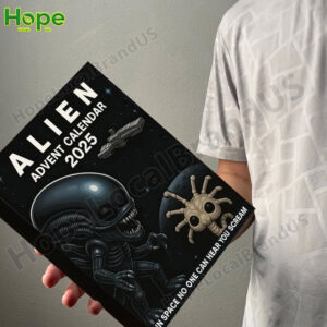 A person holds the Alien Advent Calendar 2025 box in their hand showing its size and front cover design!