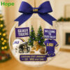 A clear round LSU Tigers holiday ornament with a helmet jersey and tiger figurines inside!