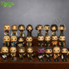 A collection of 24 stylized figures of the Metallica band members is arranged on a tiered wooden stand against a dark background!