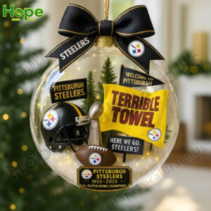 A Pittsburgh Steelers anniversary ornament contains a helmet a trophy and a yellow Terrible Towel inside a clear globe!