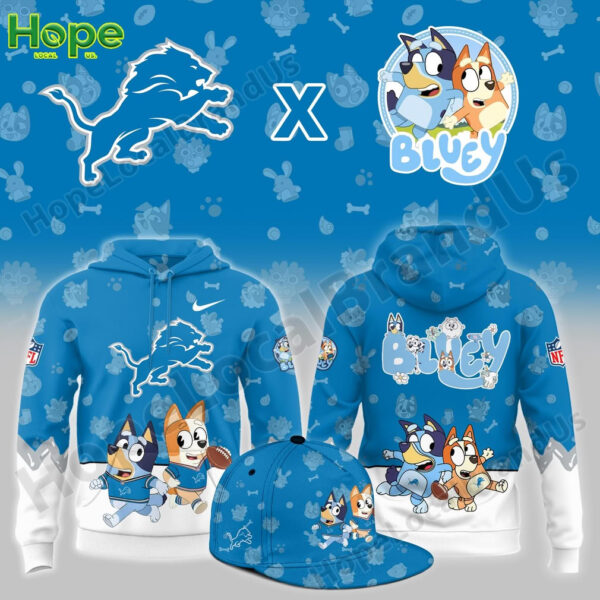 A blue hoodie featuring Bluey and Bingo from the children's show "Bluey" alongside the Detroit Lions logo. The hoodie has a playful design with characters in sports outfits, engaging in activities like football, with paw prints and other cute symbols in the background.