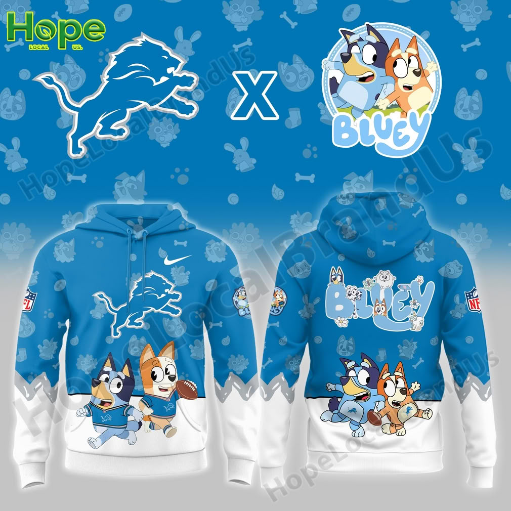 A close-up view of a blue hoodie with a larger design showing Bluey and Bingo, from the show "Bluey," paired with the Detroit Lions logo. The hoodie features a bold graphic with the characters running in sports outfits.