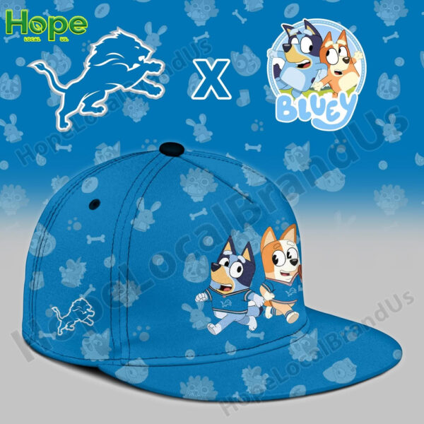 A blue baseball cap featuring Bluey and Bingo alongside the Detroit Lions logo. The cap has a fun design with the animated characters in sports outfits.