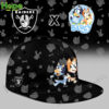 A black cap with the Las Vegas Raiders logo and Bluey and Bingo running with a football design on the front.