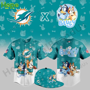 A Miami Dolphins x Bluey and Bingo collaboration jersey featuring the characters Bluey and Bingo running with a football, set against a teal background.