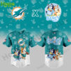A Miami Dolphins x Bluey and Bingo collaboration jersey with Bluey and Bingo featured in front, surrounded by Dolphins logos and playful graphics.