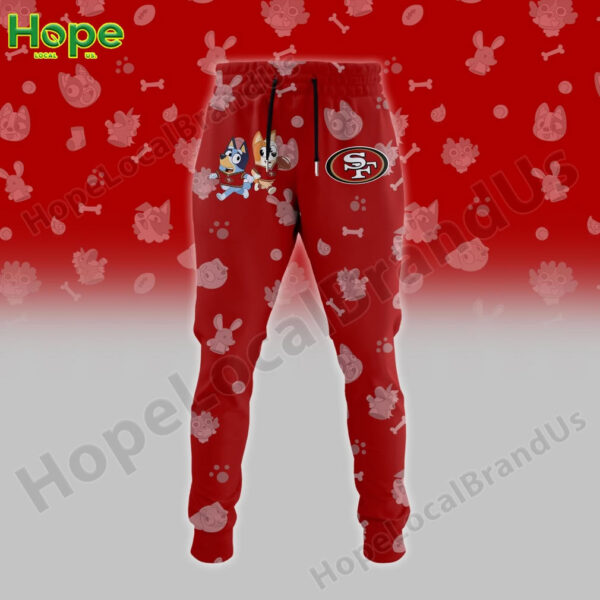 Red joggers with a San Francisco 49ers logo on one leg and Bluey and Bingo characters on the other!
