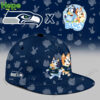 A close up of a navy blue cap with Bluey and Bingo on the front and a Seattle Seahawks logo on the side!
