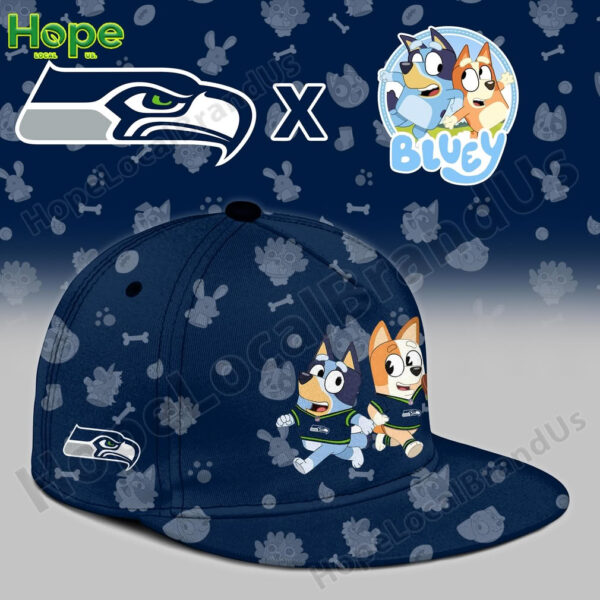 A close up of a navy blue cap with Bluey and Bingo on the front and a Seattle Seahawks logo on the side!