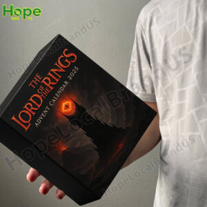 A person is holding the black Lord of the Rings Advent Calendar box that features the Tower of Barad dur and the Eye of Sauron!